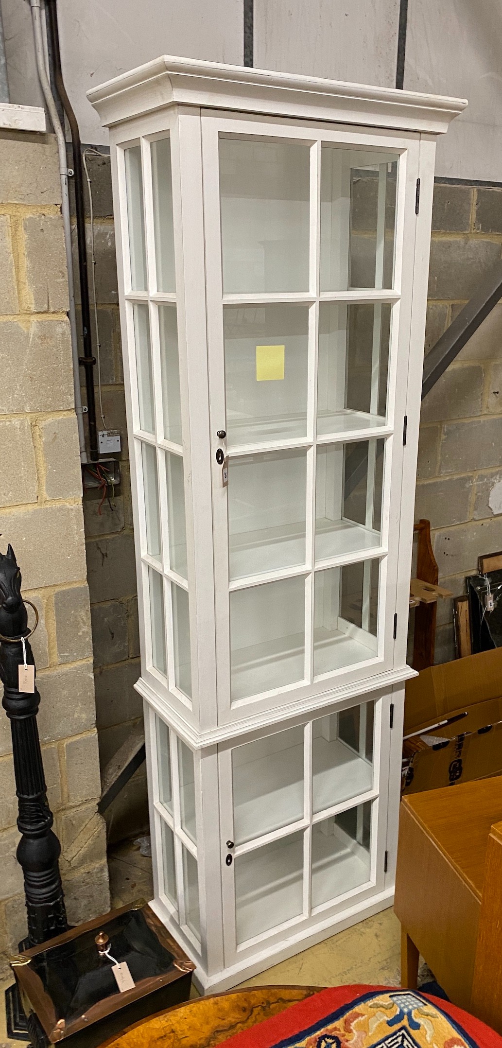A white painted display cabinet, width 73cm, depth 39cm, height 230cm